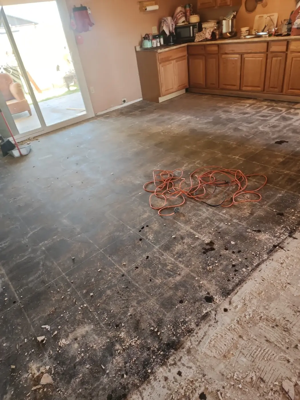 Flooring removed across a kitchen and living area