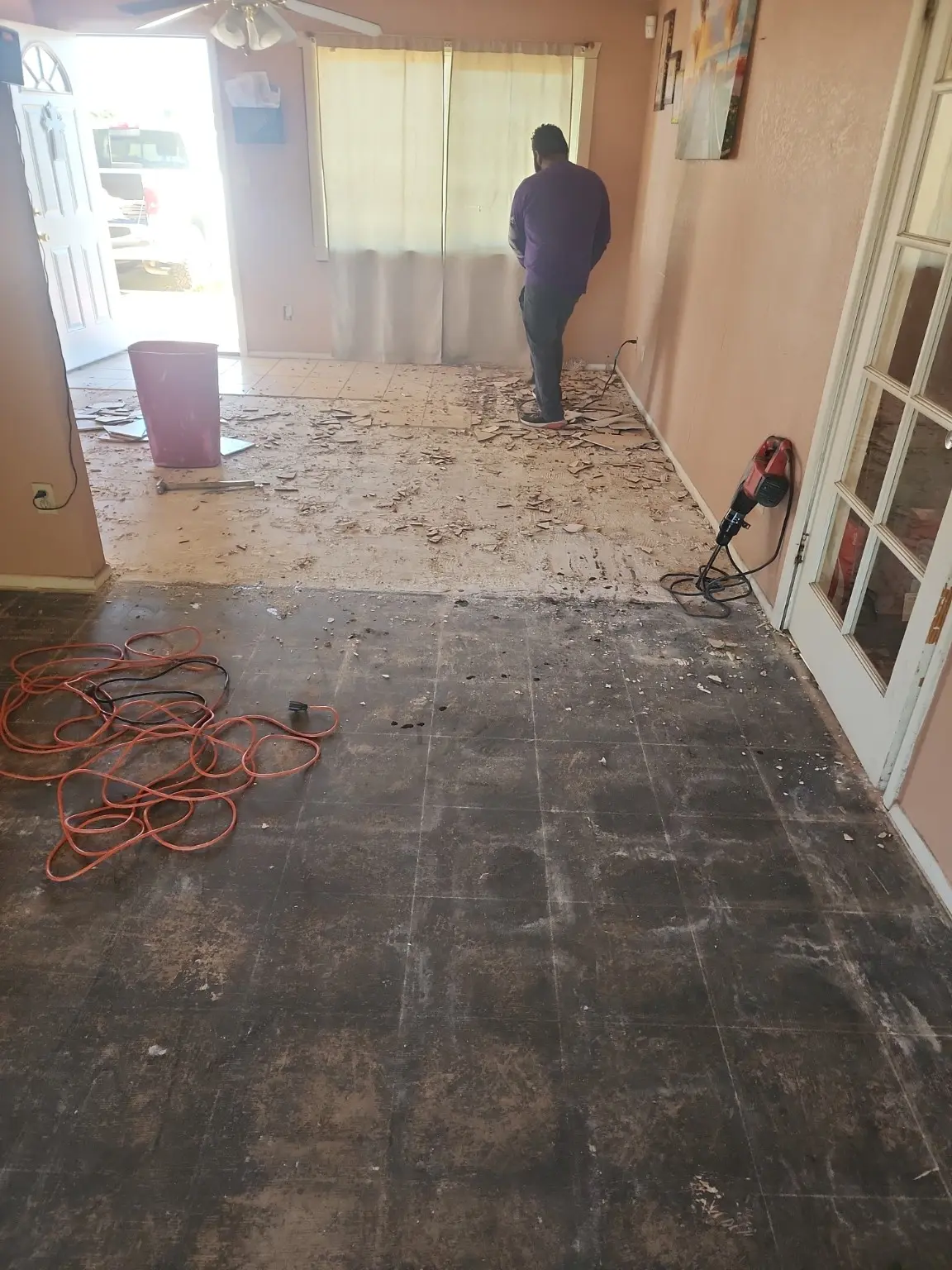 Garcia's Demolition worker removing flooring during a Phoenix-area interior project