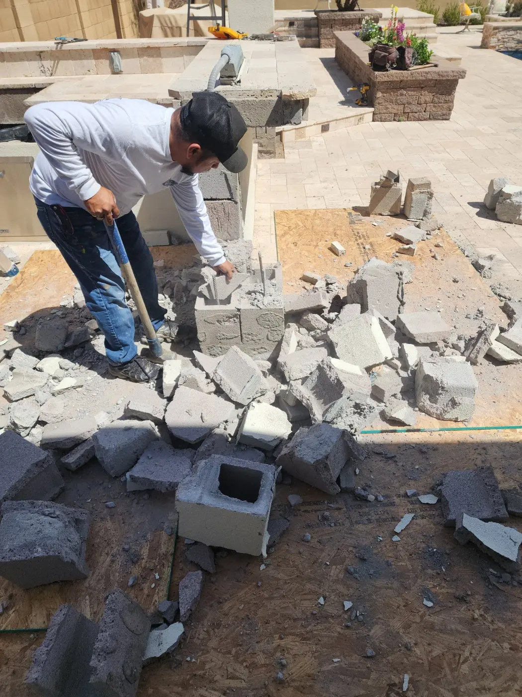 Patio masonry wall being dismantled during a separate block removal project